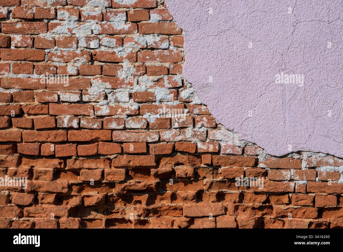 Beauté altérée – mur de briques roses fissurées. Banque D'Images