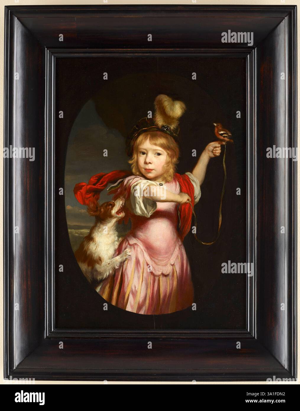 Portrait d'un garçon en robe classique avec un Bullfinch et Spaniel. Nicolaes Maes. c. 1670. Banque D'Images