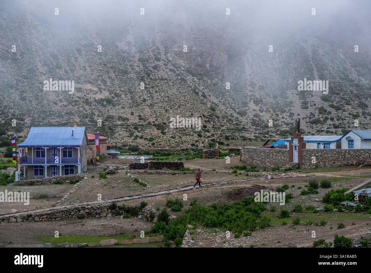 Une personne marche à travers le village vide de Nar dans la zone reculée du Népal rural. Banque D'Images