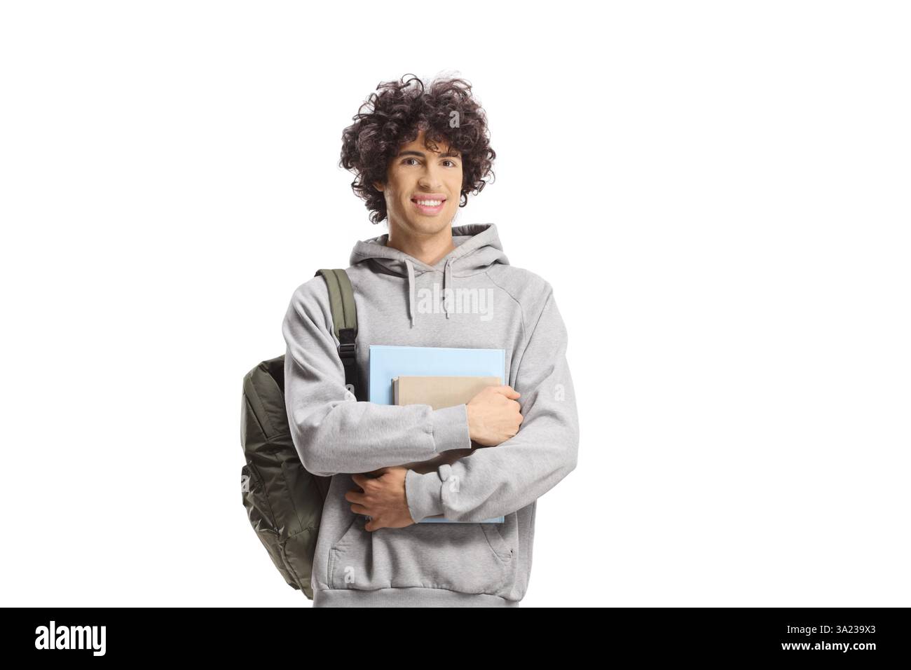 Étudiant masculin avec les cheveux bouclés portant un sac à dos et des livres isolés sur fond blanc Banque D'Images