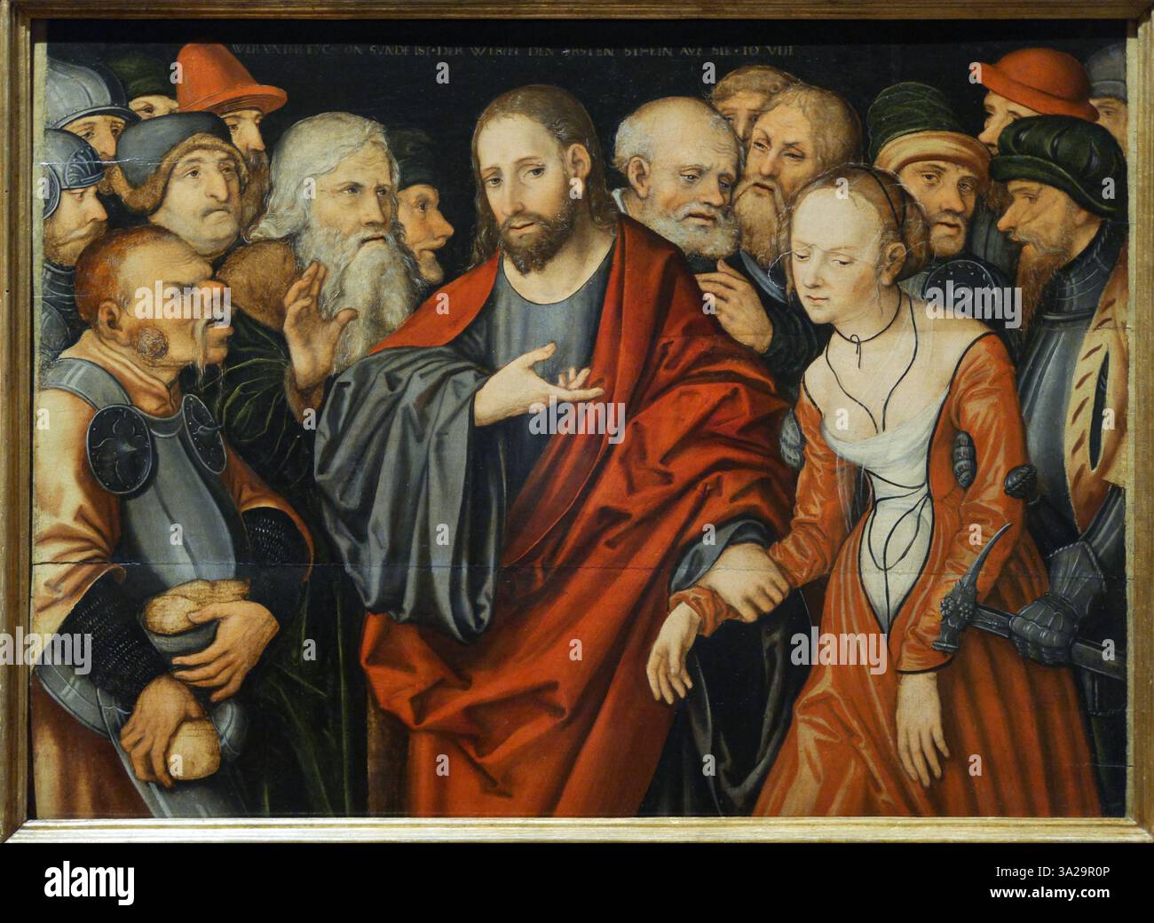 Cette peinture, créée par l'atelier de Lucas Cranach, représente la scène biblique du Christ et de la femme prise dans l'adultère, mettant l'accent sur les thèmes de la miséricorde et du pardon. Banque D'Images