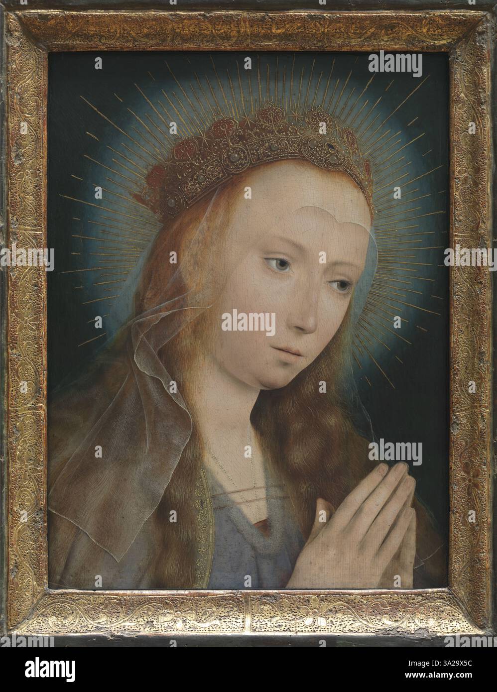Quinten Massys 'Virgin at Prayer' de 1505 présente la Vierge Marie dans une pose priante, reflétant la dévotion et la piété. L'œuvre démontre l'habileté de l'artiste à capturer la profondeur émotionnelle à travers des expressions faciales subtiles. Banque D'Images