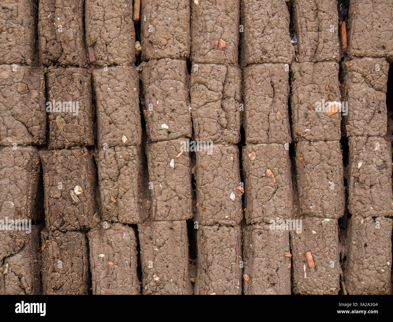 Vue rapprochée d'une section d'un mur de briques en adobe mal construit, dans une maison de la ville coloniale de Villa de Leyva, dans le centre de la Colombie. Banque D'Images