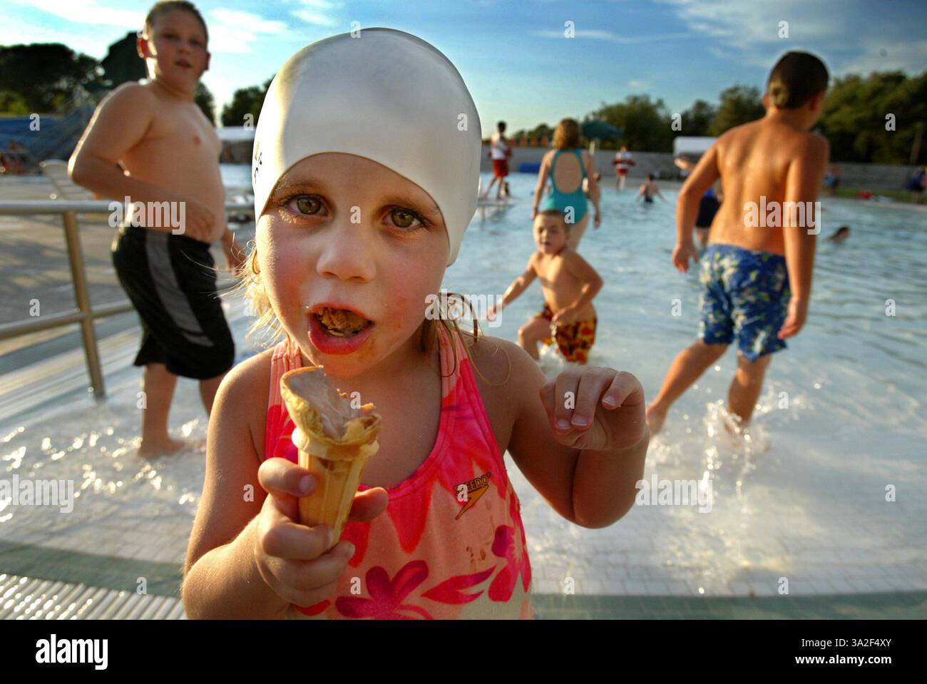 Chef de file : Aubrey Monteiro 3 ans, originaire d'Orangevale déguste sa crème glacée au bord de la piscine. Environ 200 personnes ont assisté à la fête annuelle de la crème glacée d'Orangevale cet été. L'événement a eu lieu au Centre communautaire Orangevale avec une offre illimitée de plusieurs saveurs de crème glacée. . Photo prise &/ 18/ 03. (Crédit : © Sacramento Bee/ZUMAPRESS.com) Banque D'Images