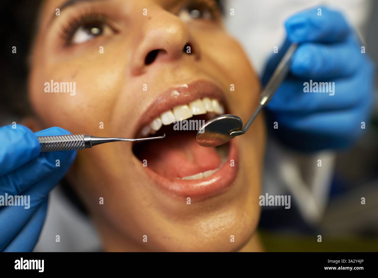 Gros plan sur le bilan dentaire avec le patient et le dentiste explorant l'hygiène bucco-dentaire Banque D'Images