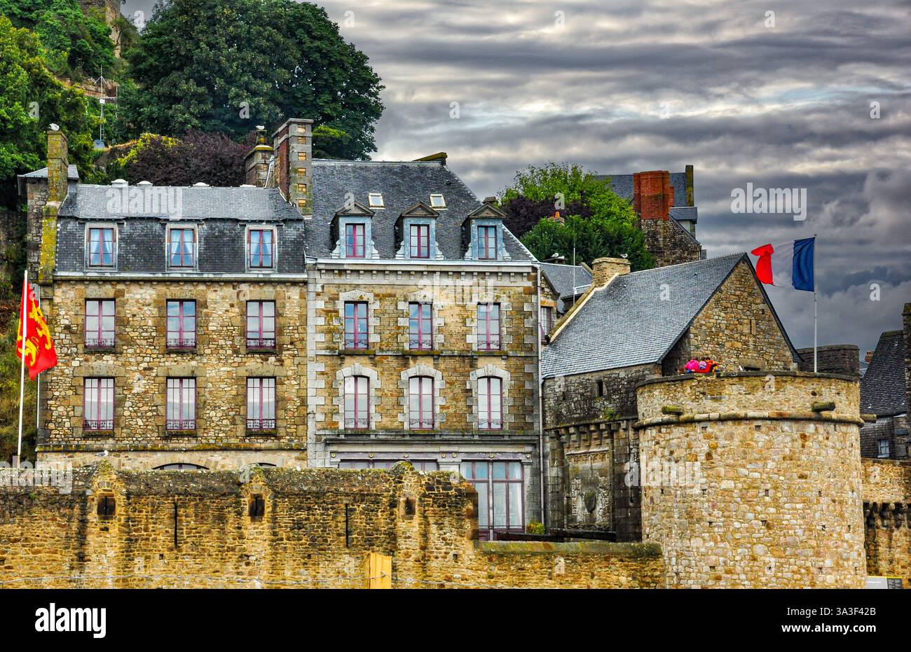Vue sur le Mont Saint Michel avec drapeau français agitant fièrement, Normandie Banque D'Images