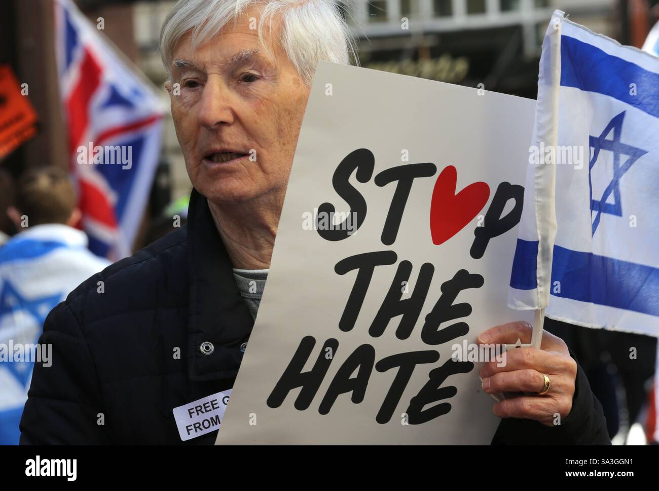 Londres, Royaume-Uni. 15 mars 2025. Un manifestant tient une pancarte disant « arrêtez la haine » pendant la contre-manifestation. Les manifestants pro-israéliens se rassemblent dans Coventry Street à Londres comme contre-manifestation à un rassemblement pro-palestinien. Les manifestants exigent le retour immédiat de tous les otages détenus par le Hamas. Ils portent des masques Batman et tiennent des pancartes et des ballons orange en hommage à Ariel Bibas, un amoureux de 4 ans du personnage de dessin animé qui a été tué avec d'autres membres de sa famille après une attaque aérienne israélienne alors qu'ils étaient retenus en otage à Gaza. Crédit : SOPA images Limited/Alamy Live News Banque D'Images Londres, Royaume-Uni. 15 mars 2025. Un manifestant tient une pancarte disant « arrêtez la haine » pendant la contre-manifestation. Les manifestants pro-israéliens se rassemblent dans Coventry Street à Londres comme contre-manifestation à un rassemblement pro-palestinien. Les manifestants exigent le retour immédiat de tous les otages détenus par le Hamas. Ils portent des masques Batman et tiennent des pancartes et des ballons orange en hommage à Ariel Bibas, un amoureux de 4 ans du personnage de dessin animé qui a été tué avec d'autres membres de sa famille après une attaque aérienne israélienne alors qu'ils étaient retenus en otage à Gaza. Crédit : SOPA images Limited/Alamy Live News Banque D'Images