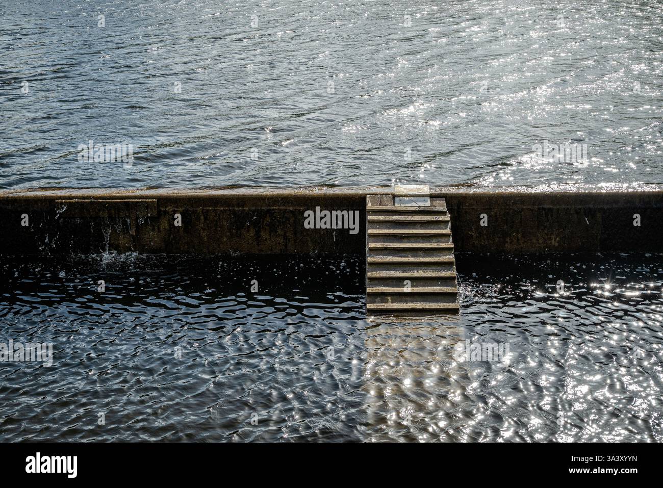 Un système de débordement de lac d'eau douce avec de l'eau ondulée en douceur régule le débit, empêchant les inondations tout en préservant cette ressource précieuse Banque D'Images
