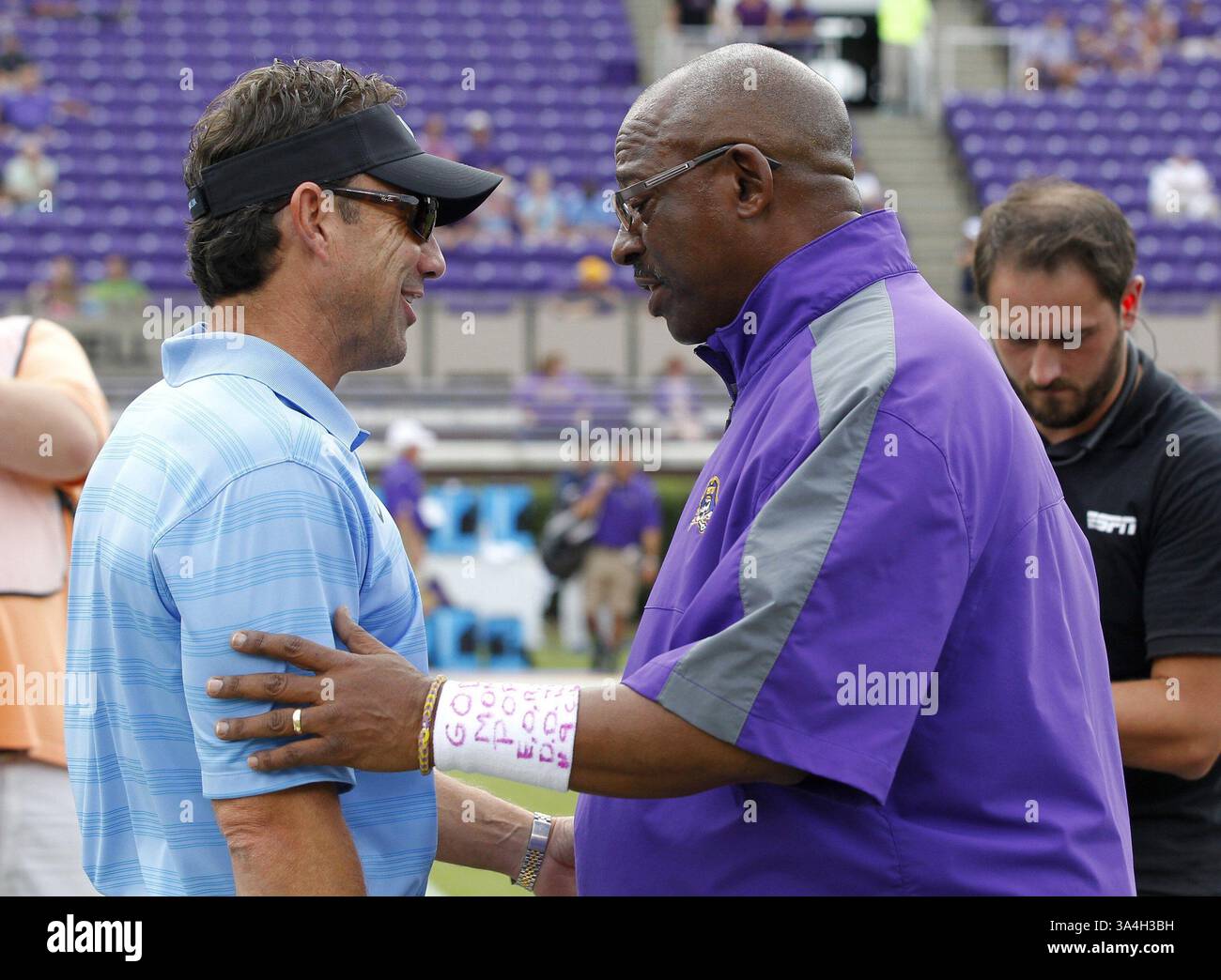 20 septembre 2014 - Raleigh, NC, USA - L'entraîneur-chef de la Caroline du Nord Larry Fedora, à gauche, accueille l'entraîneur-chef de la Caroline de l'est Ruffin McNeill avant le match de l'UNC contre la Caroline de l'est au stade Dowdy-Ficklen de Greenville, Caroline du Nord, samedi 20 septembre 2014. (Crédit image : © Ethan Hyman/MCT/ZUMA Wire) Banque D'Images
