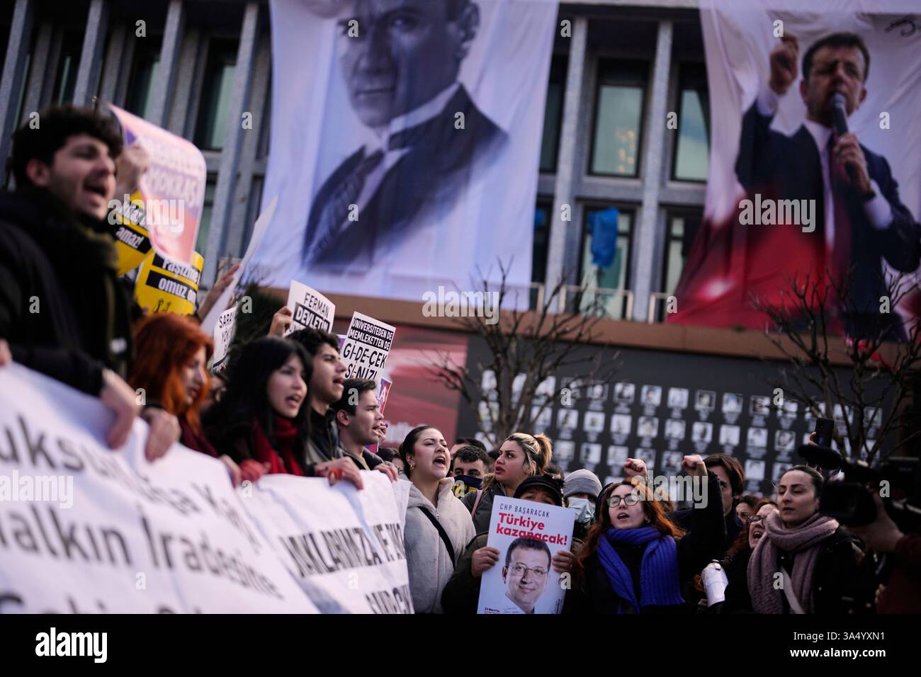 University students shout slogans as they march to protest the arrest ...