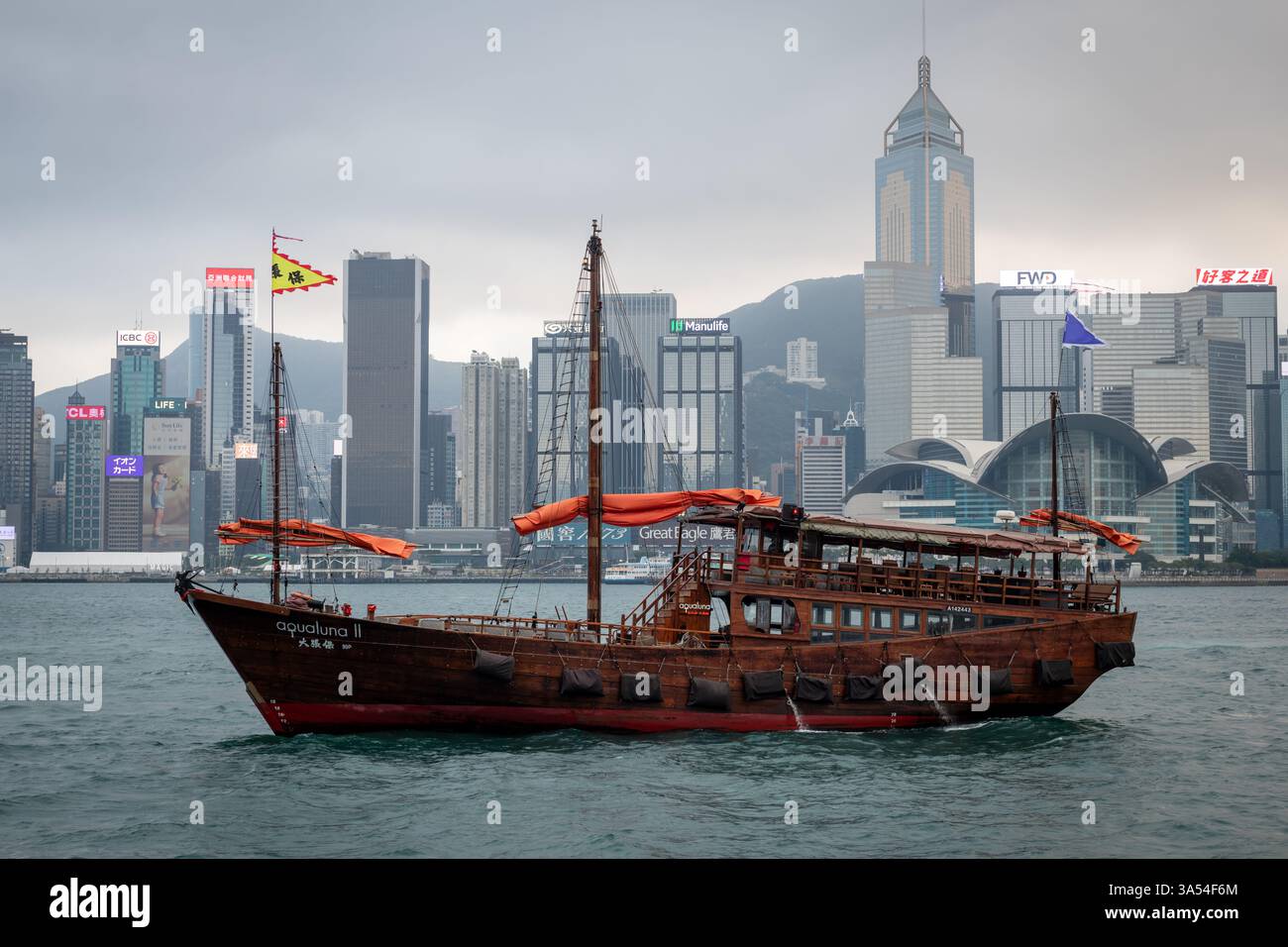 Hong Kong. Chine- 02.20.2025. L'Aqua Luna, une jonque chinoise, organise une croisière touristique emblématique dans le port de Victoria. Banque D'Images
