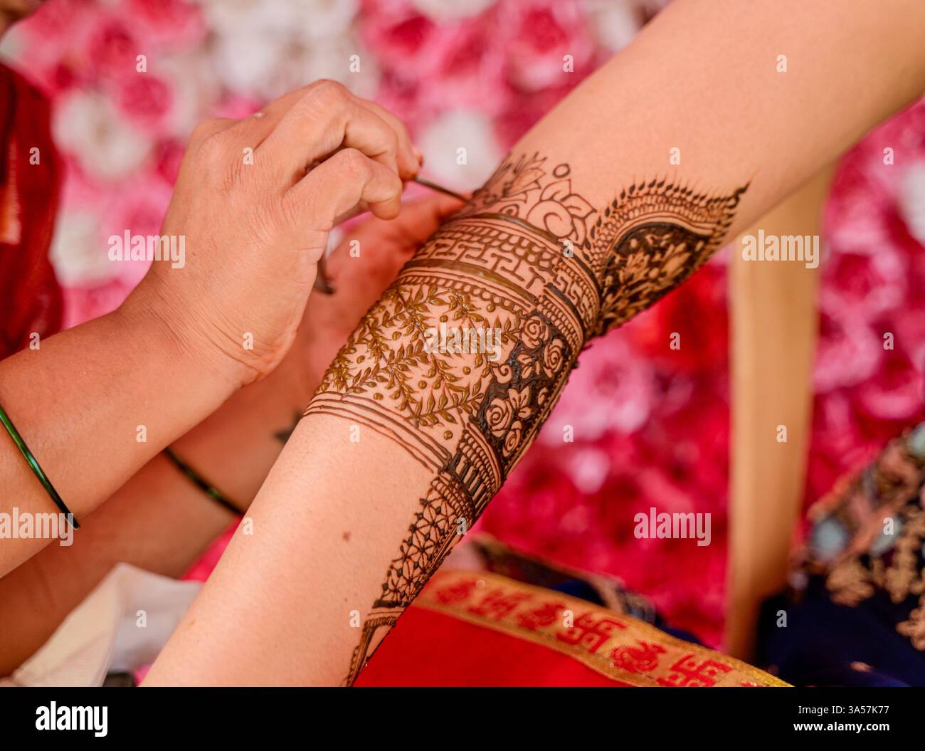 Cérémonie mehndi dans laquelle Mehndi fabrication sur la main en cours sur la main de mariée par l'artiste avant mariage indien. Banque D'Images