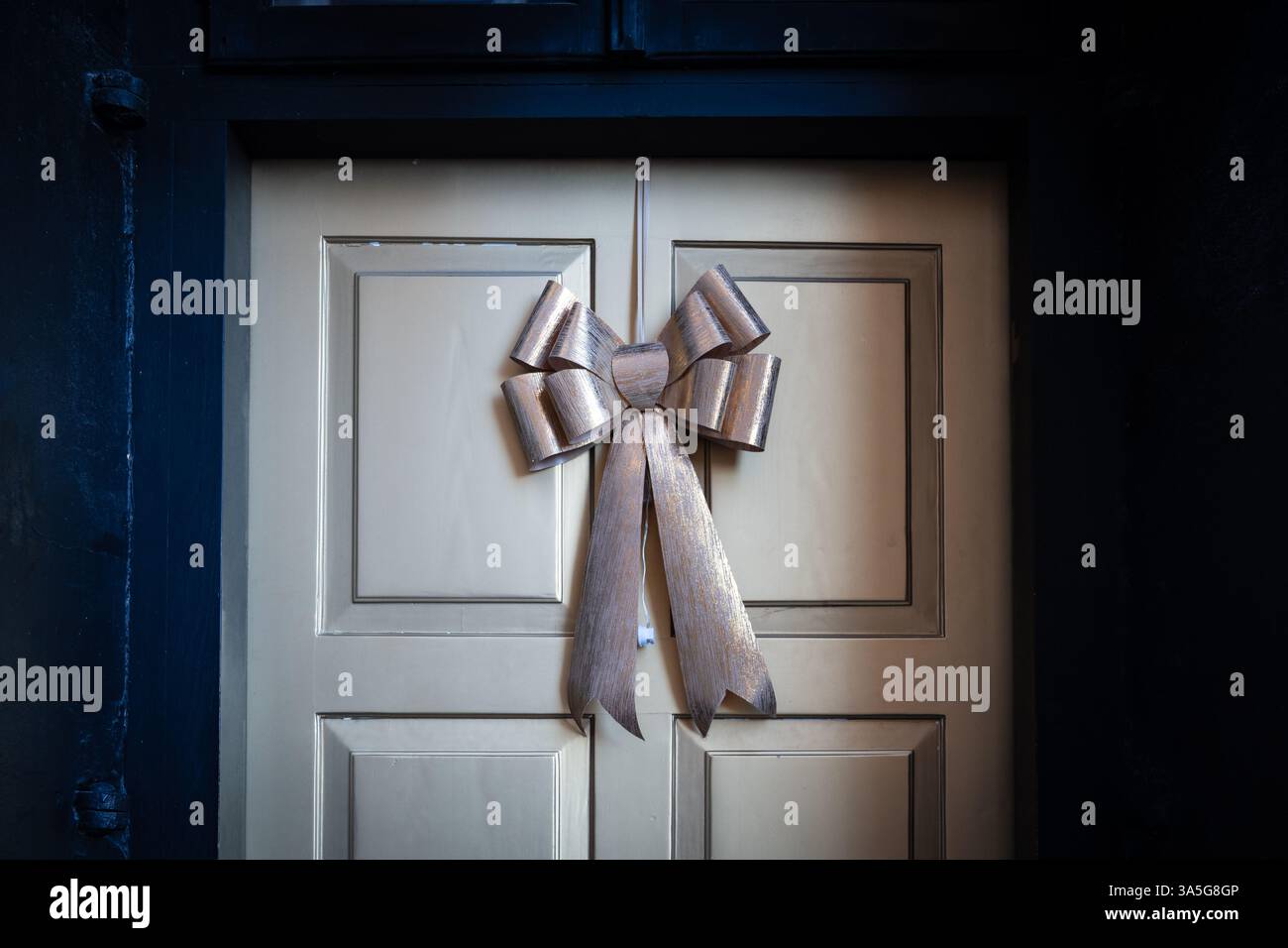 noeud de ruban décoratif beige de noël sur une vieille porte Banque D'Images