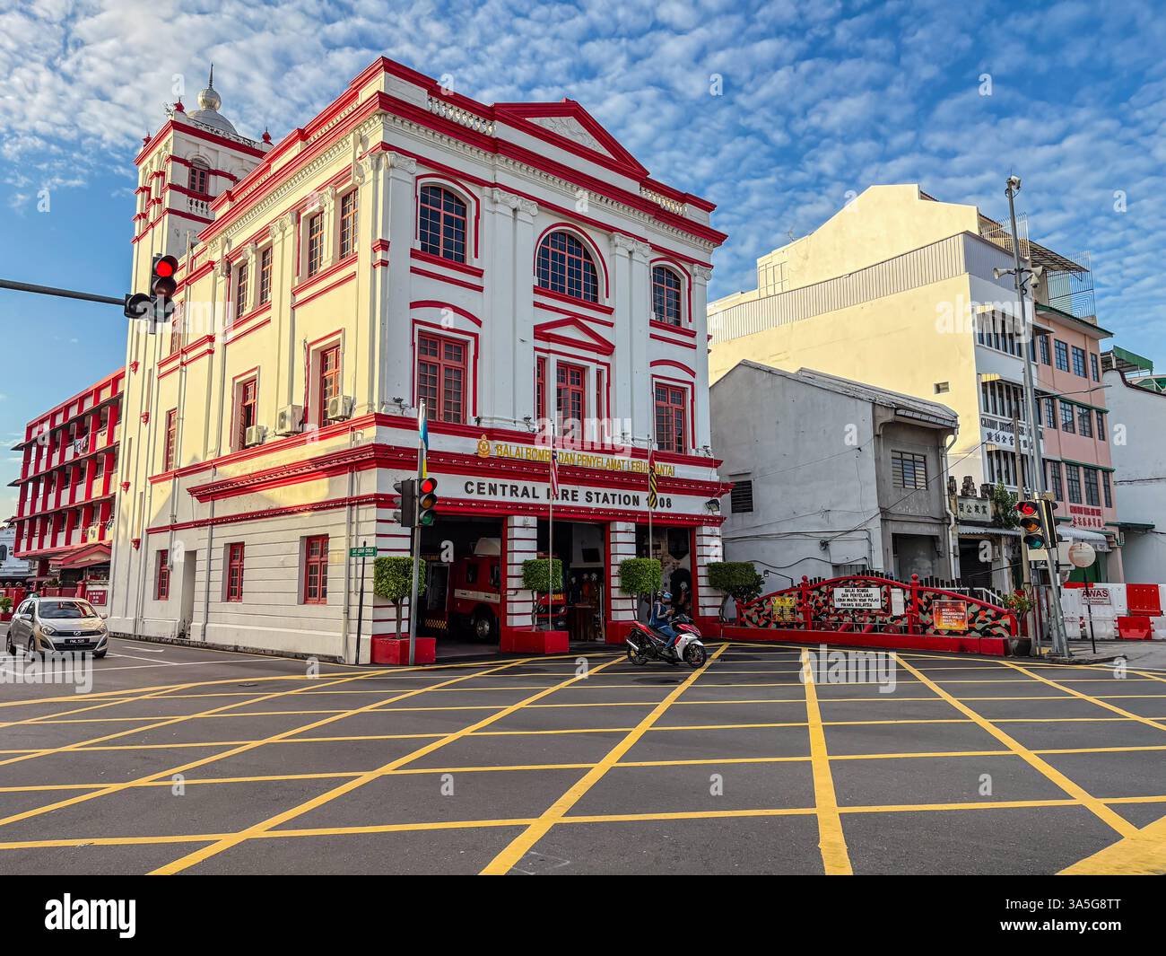 Centrale de pompiers, construite en 1908, à George Town, Penang, Malaisie. Vue latérale avec passage de moto. Banque D'Images