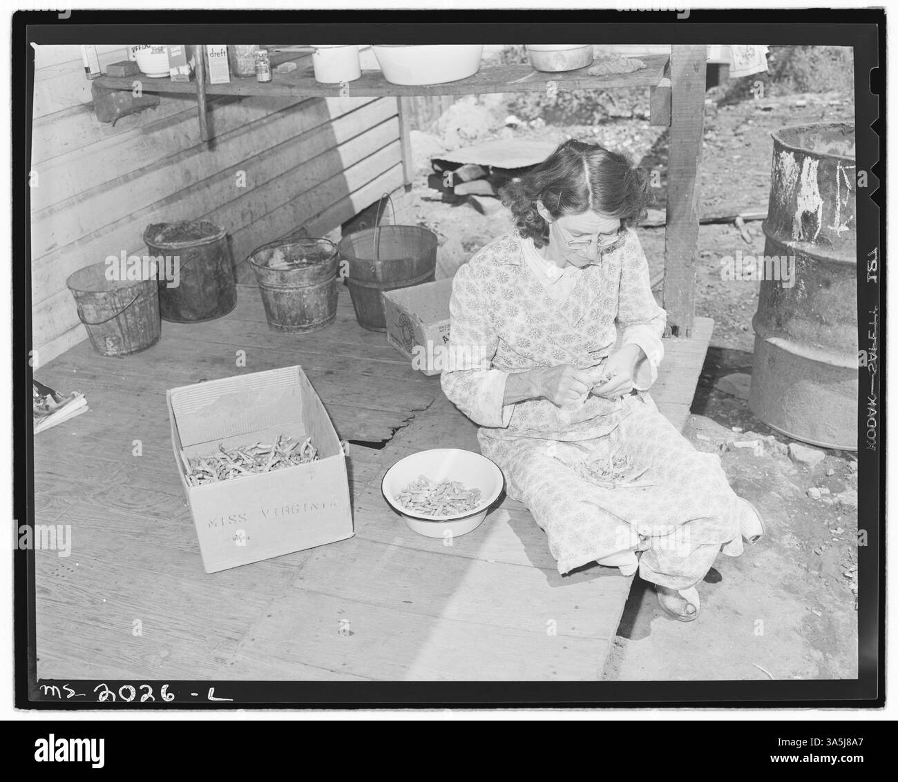 La femme d'un mineur de la mine Bradshaw dans le comté de McDowell, Virginie-occidentale, a photographié des pois cassants sur son porche arrière, représentant la vie quotidienne dans une communauté minière de charbon dans les années 1940 Banque D'Images
