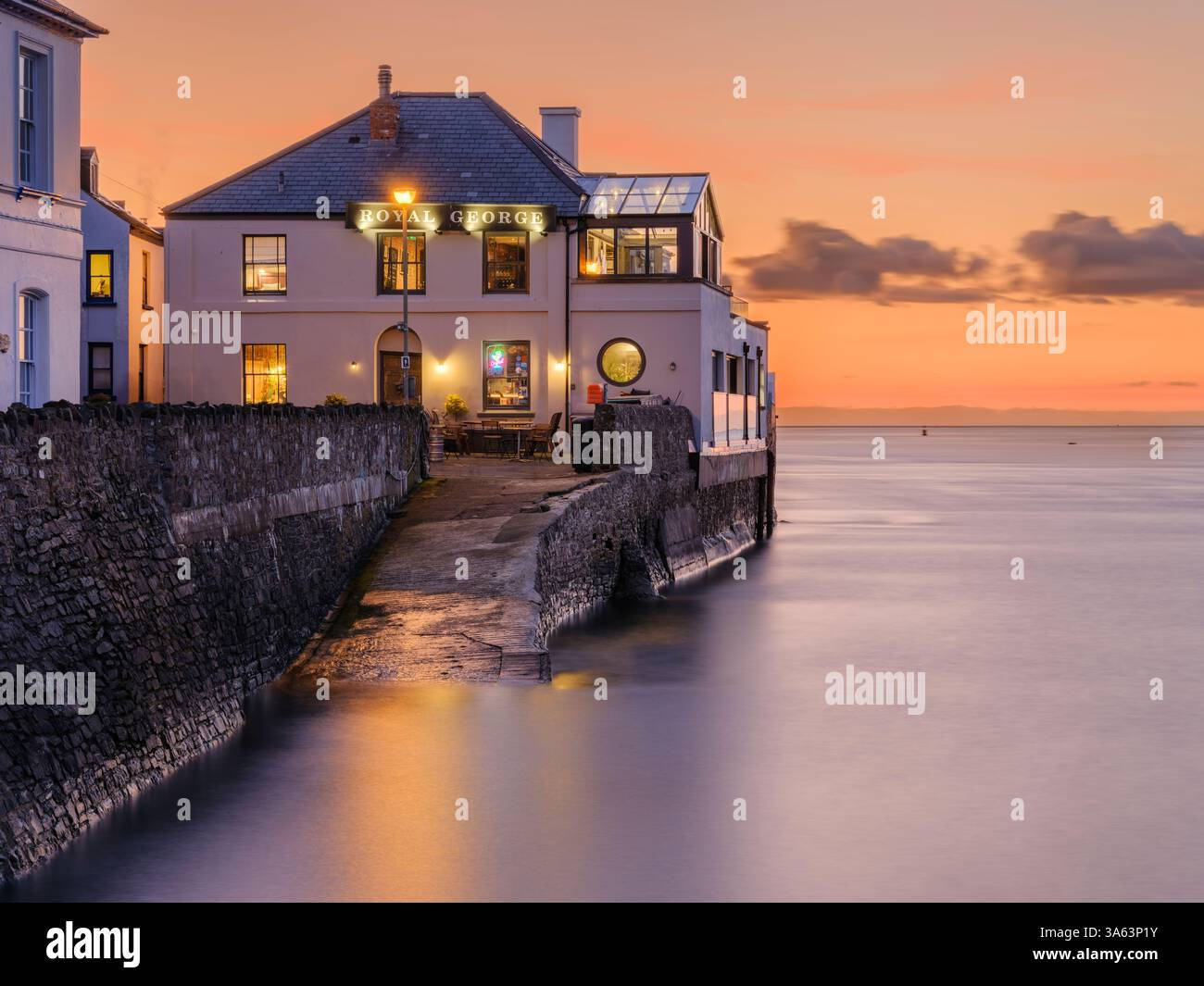 Appledore, North Devon - par une soirée calme juste avant le coucher du soleil sur l'estuaire de la rivière Torridge, le Royal George se démarque sur un ciel orangé Banque D'Images