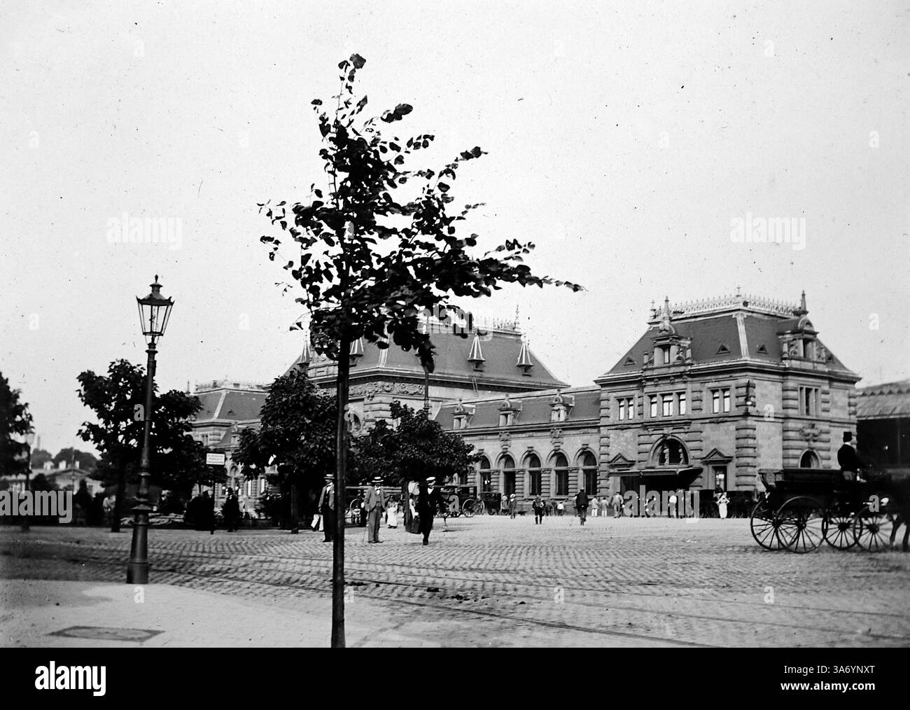 Le Bahnhof (gare) à Dusseldorf, Allemagne. Une scène de rue avec des gens et une charrette tirée par des chevaux devant la gare. D’après une collection de photographies d’une tournée européenne familiale qui s’est déroulée en 1899. Les photographies originales étaient d'environ 3 ½ x 2 ½ pouces et présentent une vue intéressante des coutumes, des modes et de l'histoire sociale de la fin de la période victorienne. Banque D'Images