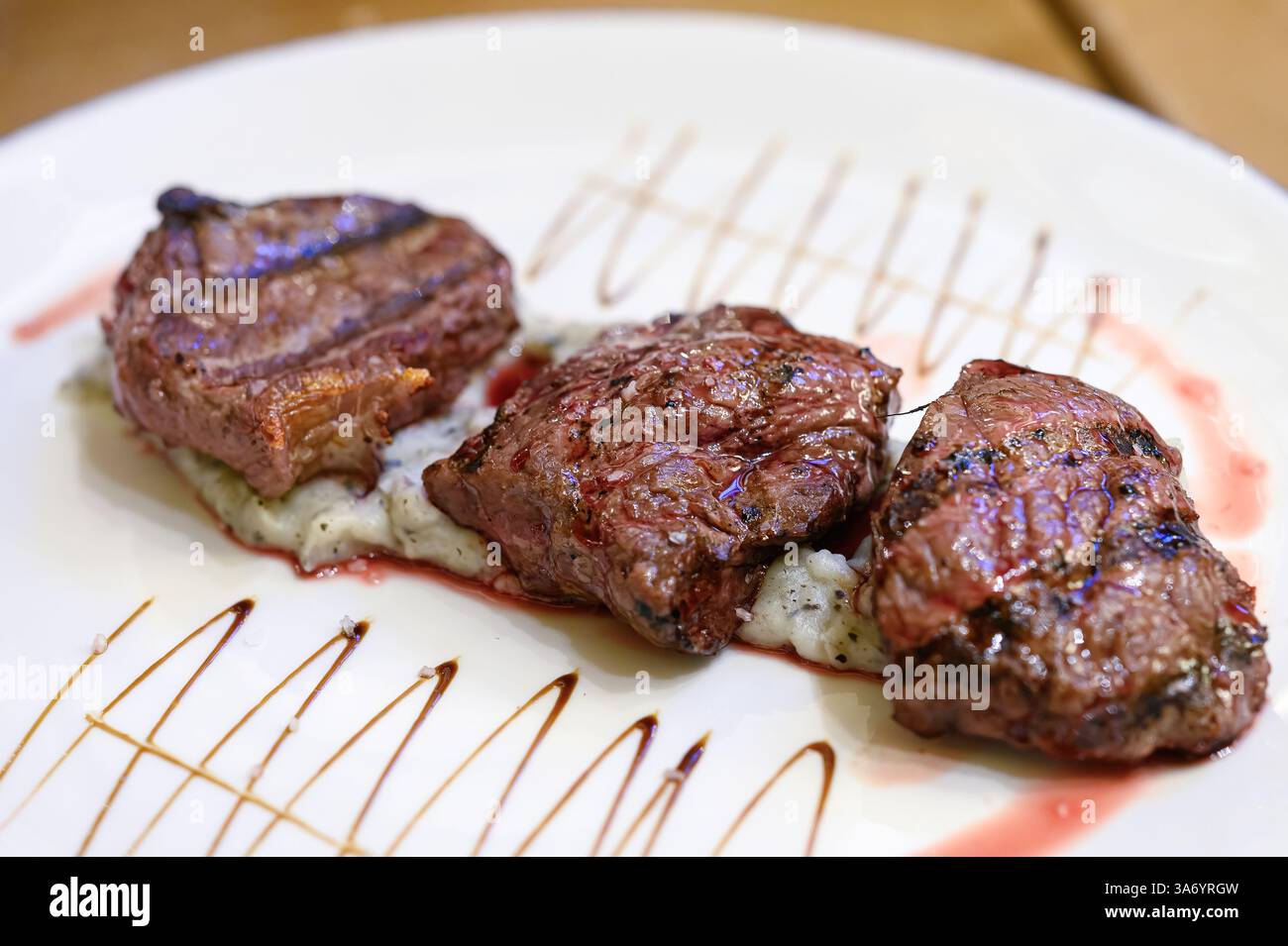 Filet de bœuf cuit servi sur une assiette dans un cadre de restaurant. Banque D'Images