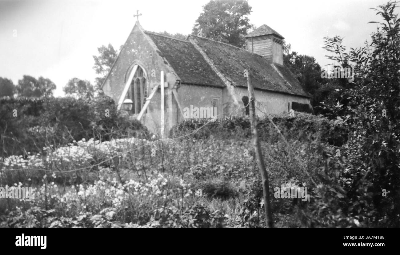 1930. Vue arrière de l'église d'Andrew dans le village de Timsbury, Hampshire, Angleterre, un bâtiment historique classé Grade II. Une grande partie du sol derrière l'église est envahie par la végétation. L'église a une histoire riche, avec des parties datant du début du XVe siècle. D'une collection de photographies amateurs non attribuées dans la plage de dates, 1929-1936, qui comprennent les vacances britanniques et européennes. La plupart des images originales étaient d'environ 3 ½ x 2 pouces. Banque D'Images