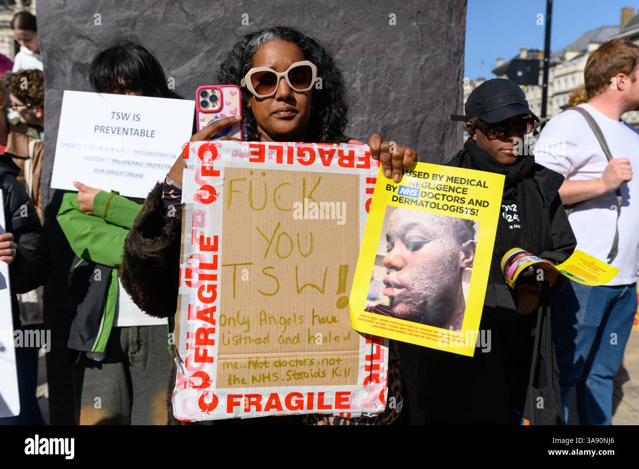 Londres, Royaume-Uni, 29 mars 2025. Les personnes qui souffrent ou ont souffert de sevrage topique des stéroïdes, également connu sous le nom de syndrome de la peau rouge, se sont rassemblées devant l’hôpital St Thomas à Londres pour protester contre les médecins et les dermatologues qui ont prescrit trop de stéroïdes pour traiter l’eczéma, causant aux patients de souffrir de TSW. Crédit : Andrea Domeniconi/Alamy Live News Banque D'Images