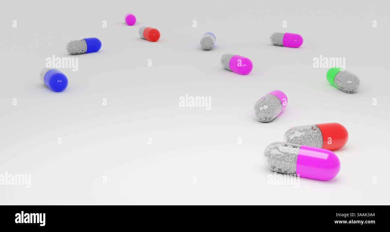 Une rangée de pilules colorées sont dispersées sur un fond blanc. Les pilules sont de différentes couleurs et tailles, créant une scène visuellement intéressante. C Banque D'Images