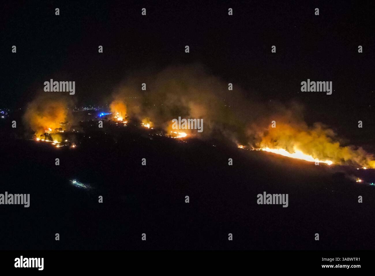 Poole, Dorset, Royaume-Uni. 3 avril 2025. Météo britannique. Vue aérienne vers un énorme feu de forêt qui flambe à Upton Heath à Poole dans le Dorset. Plusieurs services d'urgence sont présents, les voies étant fermées sur la voie de contournement A35 Upton en raison de la proximité de l'incendie. Ce dernier incendie dans la région de Bournemouth et Poole vient après une période de sécheresse prolongée avec des températures supérieures à la moyenne pour la période de l'année. Crédit photo : Graham Hunt/Alamy Live News Banque D'Images