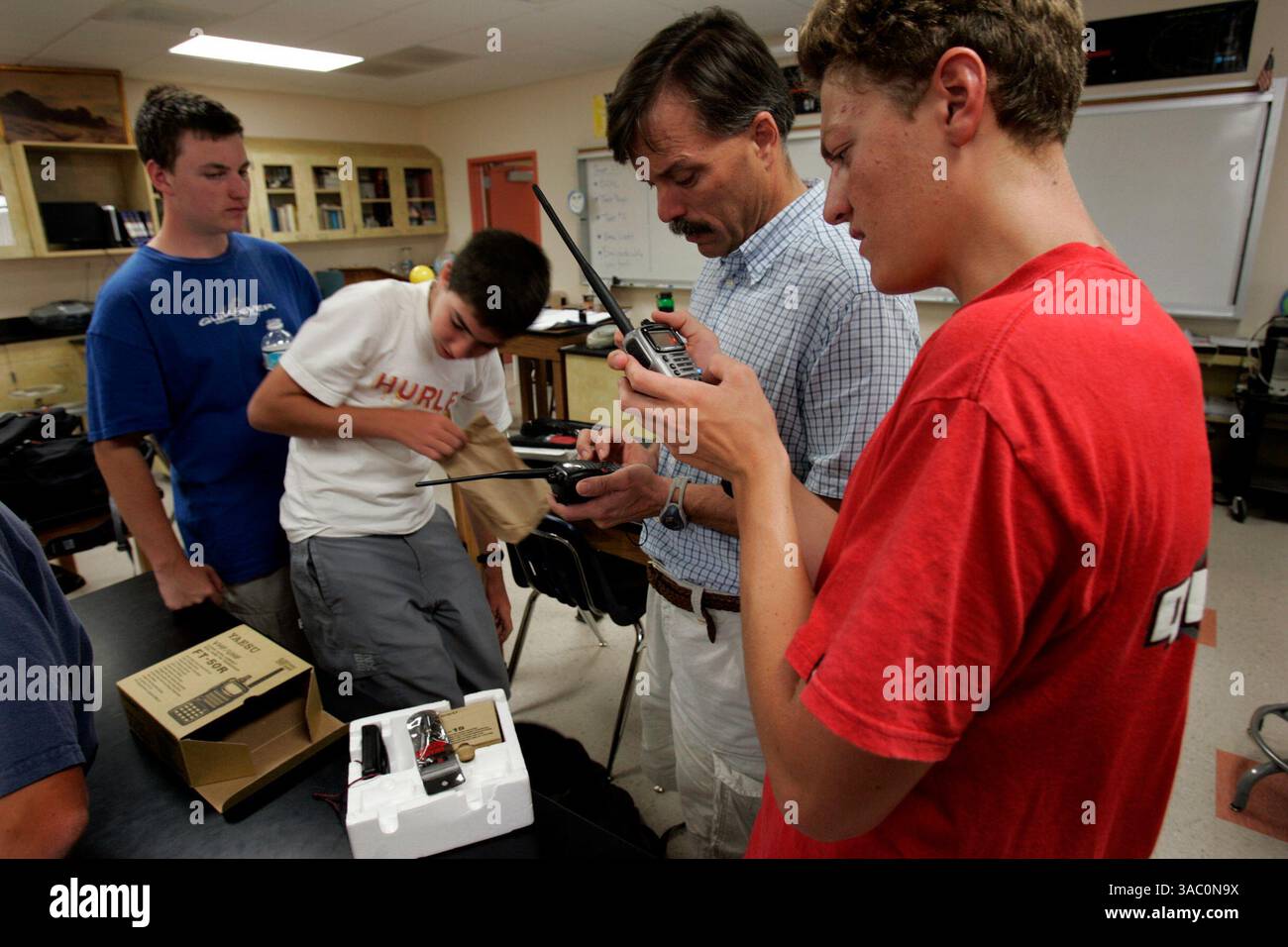 (Publié le 10/7/2005, ni-6) John Peterson, 15 ans, à gauche, Marc Russell, 15, enseignant John Earnest et Doug Martin, 16 ans, à droite, regardent une radio VHF donnée par le Palomar amateur Radio Club aux étudiants du Mt. Carmel amateur Radio Club.--Laura Embry/Union-Tribune Banque D'Images