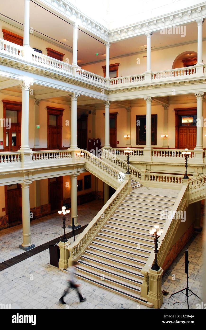 Un jeune homme approche les longues marches à l'intérieur de la Georgia State House à Atlanta, maison du gouvernement de l'État et Banque D'Images