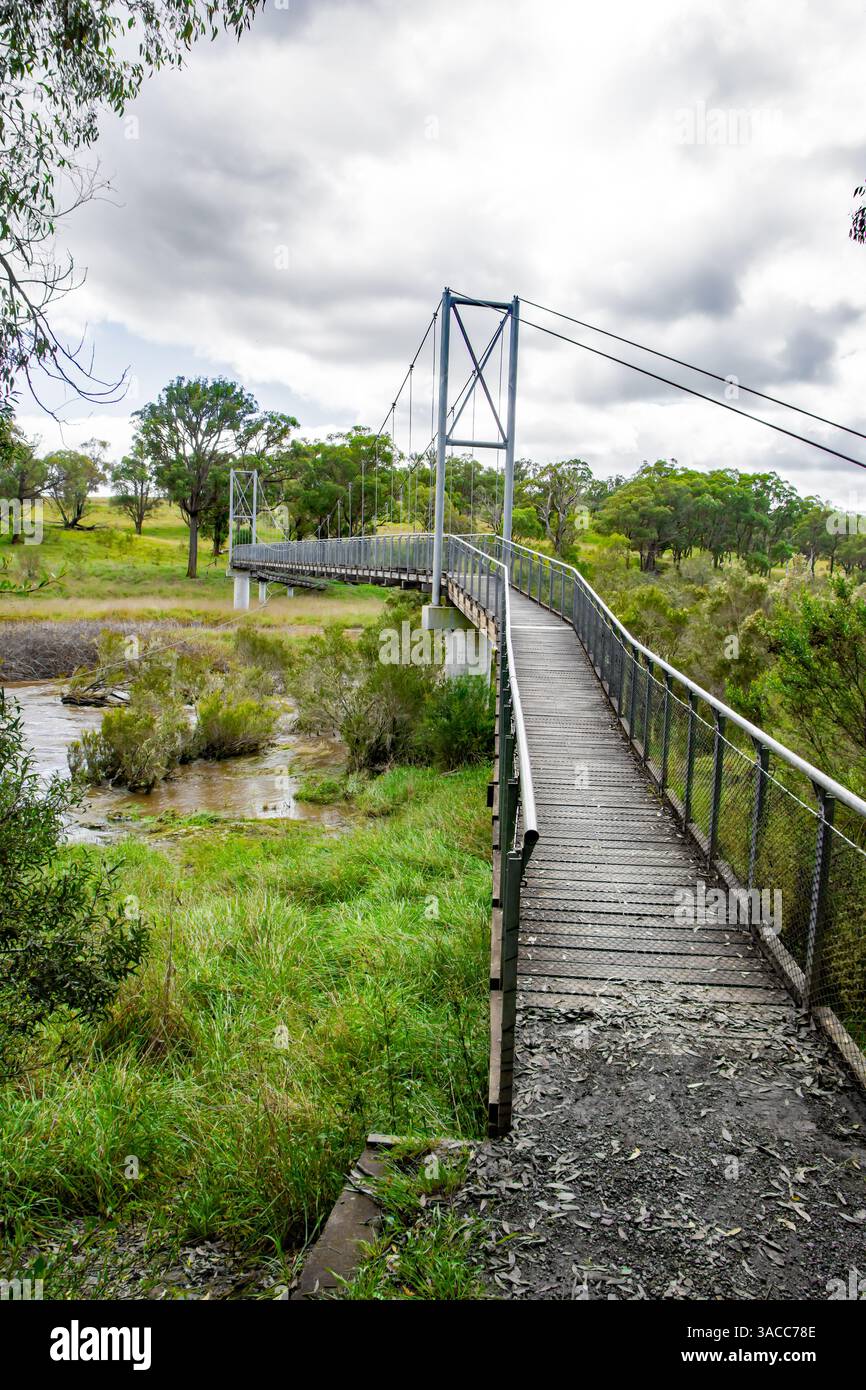 Pont suspendu piétonnier sur la rivière Apsley, Walcha, Nouvelle-Galles du Sud, Australie par un jour de pluie. Banque D'Images