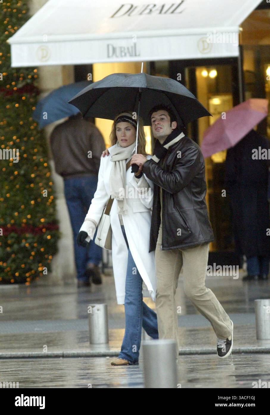 27 décembre 2002 ; Paris, France ; le footballeur du Real Madrid LUIS FIGO et sa femme HELEN SVEDIN prennent de courtes vacances loin des enfants pour faire du shopping et profiter de la compagnie de l'autre sous la pluie humide de Paris. Ils ont rendu visite à trois ou quatre bijoutiers où Luis a acheté des cadeaux pour sa belle épouse. Banque D'Images