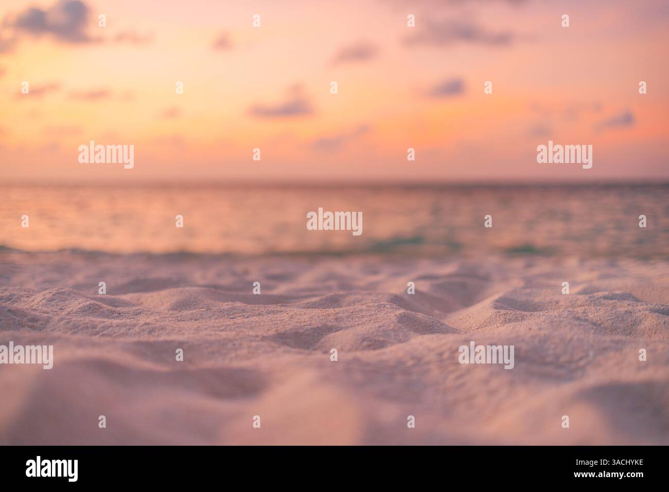 Gros plan sable doré lumière de coucher de soleil douce, plage paysage marin arrière-plan vagues douces couleurs chaudes méditation paisible, sereine côtière. Plage d'été backgrond Banque D'Images