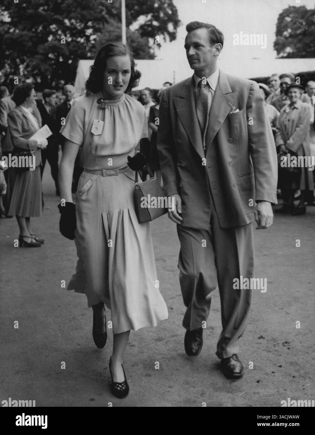 Brown arrive pour Wimbledon. Geoff Brown, de l'Australie, numéro 9 du tournoi de cette année, arrive avec sa femme pour la journée d'ouverture des Championnats de tennis sur gazon au All-England Club, Wimbledon, Londres, aujourd'hui (lundi). Brown jouait un match simple contre A. Shafei, d’Égypte. 26 juin 1950. (Photo de Reuterphoto) Banque D'Images