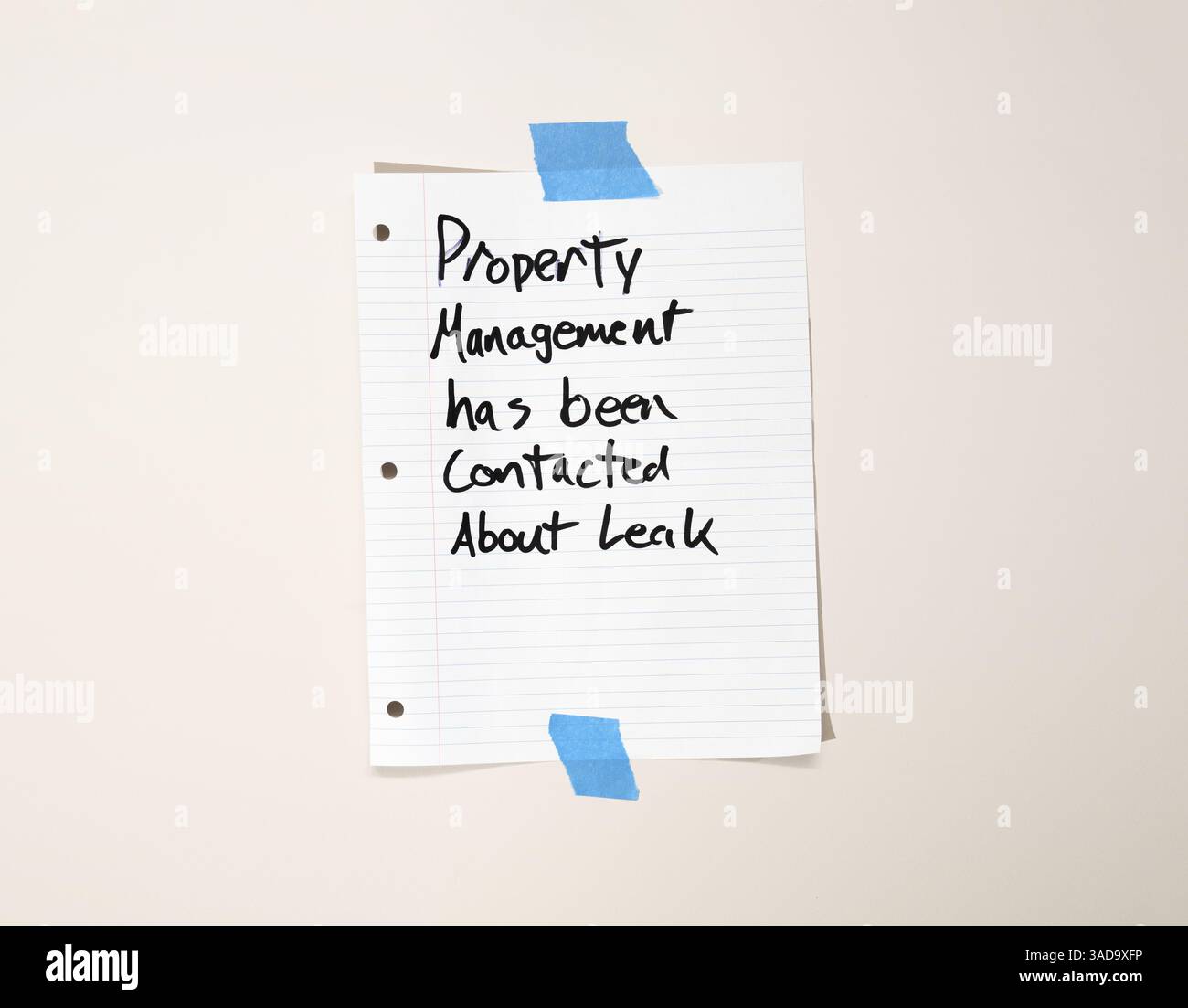 Avis manuscrit concernant une fuite d'eau signalée. Note en papier collée au mur dans le couloir d'un immeuble en copropriété ou d'un immeuble locatif. La gestion immobilière a été Banque D'Images