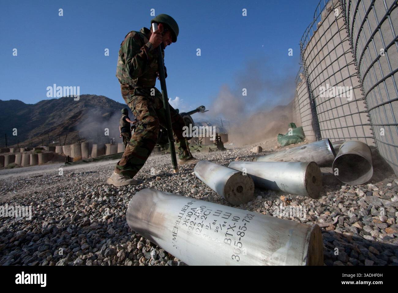 02 août 2009 - FOB Kala Gush, Nangahar, Afghanistan - un soldat de l'Armée nationale afghane jette des munitions usagées pour un canon d'artillerie D30 de 120 mm de fabrication russe tirant sur des positions taliban à partir de la base opérationnelle avancée de Kala Gush dans les montagnes Hindu Kush près de la frontière pakistanaise (crédit image : Simon Klingert/ZUMAPRESS.com) Banque D'Images