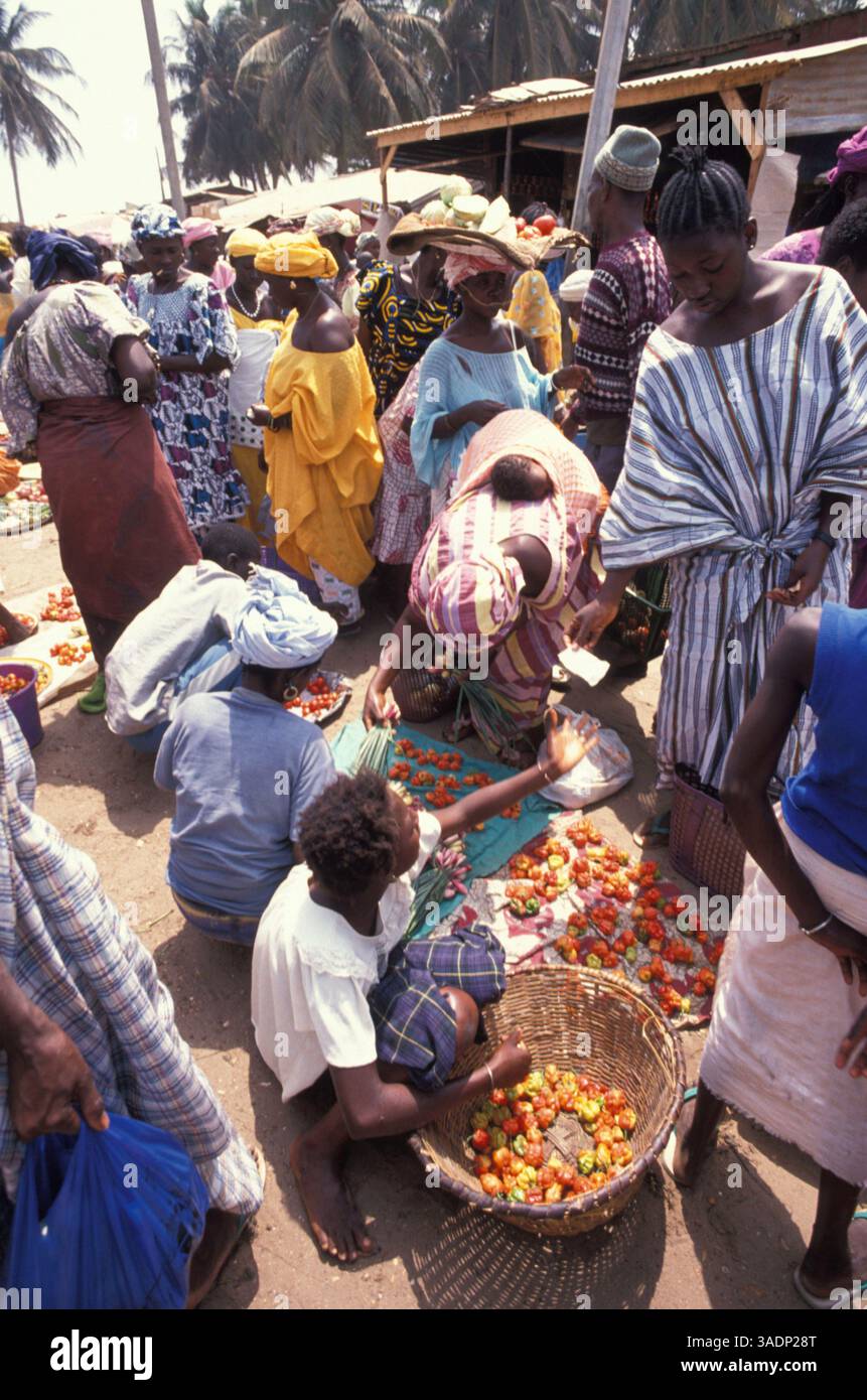 1980 - Banjul, Gambie - BANJUL (anciennement Bathurst) est la capitale de la Gambie. La population de la ville proprement dite n'est que de 34 828 habitants, mais la zone urbaine totale est beaucoup plus grande avec une population de 523 589 habitants (recensement de 2003). Il est situé sur l'île Sainte-Marie (ou île de Banjul) où le fleuve Gambie pénètre dans l'océan Atlantique. L'île est reliée au continent par des ferries de passagers et de véhicules au nord et des ponts au sud. PHOTO : marché dans les rues de Banjul (crédit image : Mario Ruiz/ZUMA Press Wire) Banque D'Images