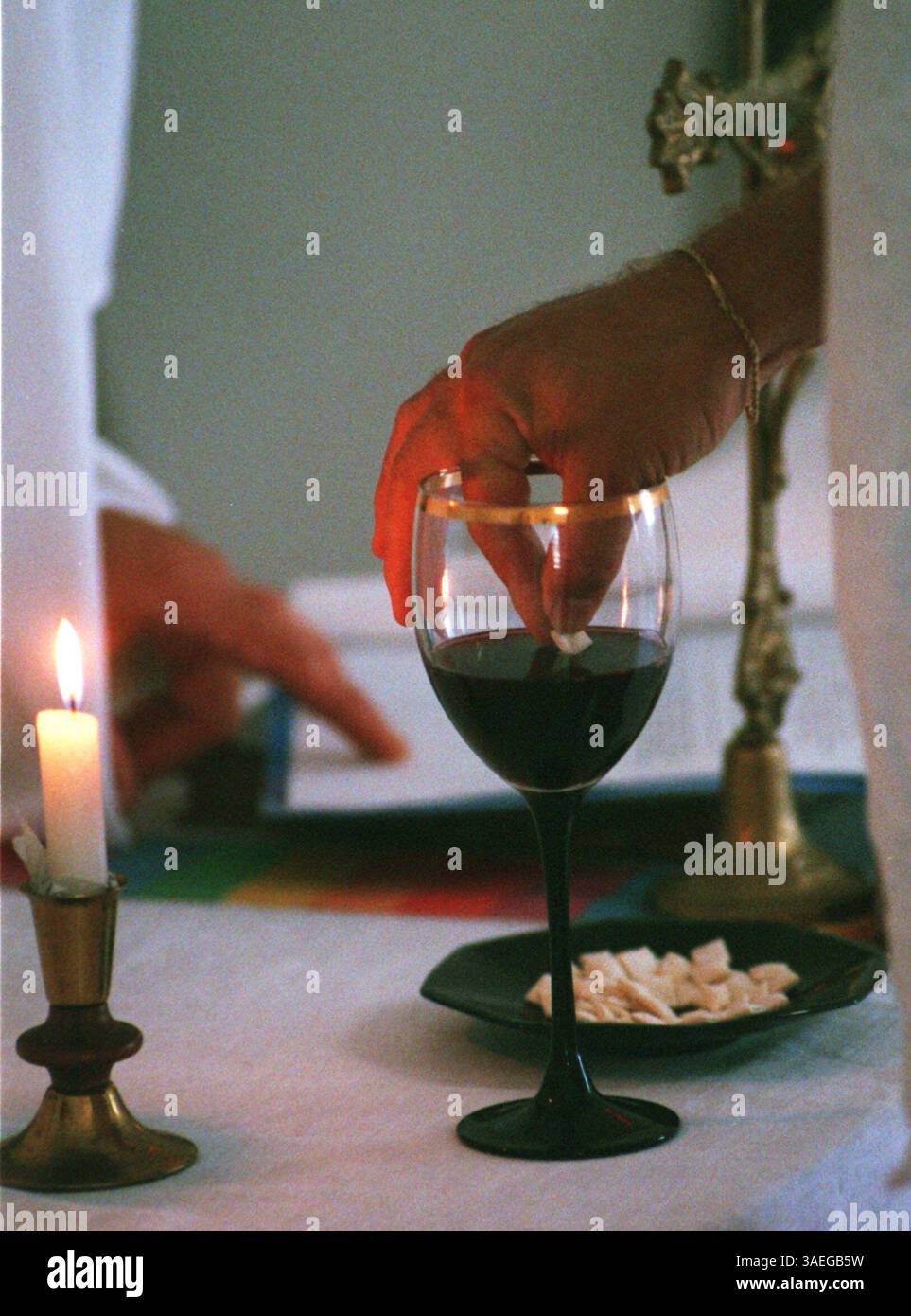 NP 36712 - - LIVRER À : np desk - - 11/1/96 - - clearwater - - LÉGENDE INFO : Holy communion at a service Friday at the Red Ribbon Homestead, 1123 Pinellas réunis, Clearwater. La communauté prend soin des patients atteints du sida/VIH. Photo #2-le pain est trempé dans le vin (crédit image : St Petersburg Times/ZUMAPRESS.com) Banque D'Images