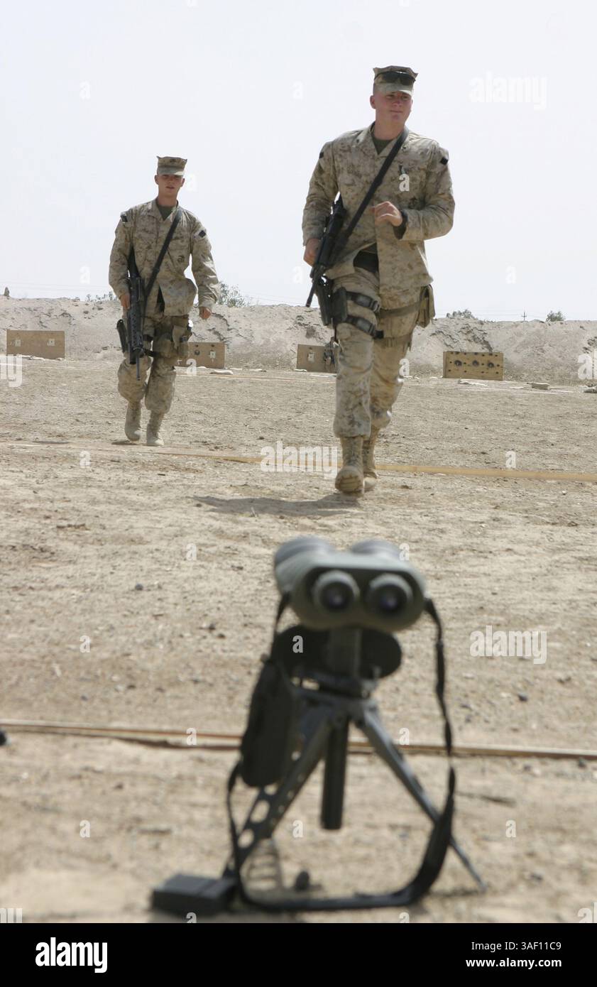 21 avril 2005 ; Camp Baharia, Irak ; lance Cpl BRIAN M. CLOONAN, tireur désigné du 1er peloton, 2e Fleet anti-Terrorism Security Team Company, Marine corps Security Force Battalion, à droite, et lance Cpl WILLIAM BLACK, également tireur désigné du 1er peloton, 2e FAST Company, à gauche, retournent à la ligne de tir après avoir vérifié leurs cibles ici le 21 avril. Les membres de l'unité se sont entraînés à ajuster les viseurs de leurs armes et à tirer les fusils à bord du 1er Bataillon, 6e Régiment de Marines ici pour maintenir leur compétence tout en assurant la sécurité des convois ici. Crédit obligatoire : photo par Cp Banque D'Images