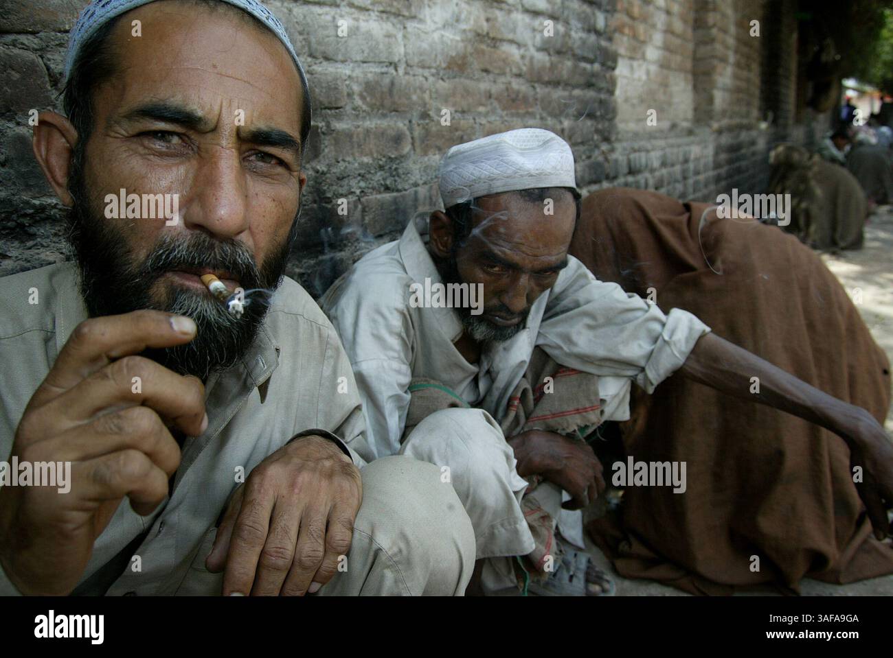 01 juin 2006 - Peshawar, PFNL, Pakistan - penchés contre un mur de pierre, les hommes fument et consomment des drogues. Des milliers d'héroïnomanes vivent dans les égouts sous les ponts de l'ouest du Pakistan. La plupart d'entre eux volent pour payer des médicaments, qui sont bon marché et facilement accessibles. En raison de leur dépendance aux drogues et de leurs conditions de vie déplorables, de nombreux consommateurs meurent jeunes. Le nombre de centres de réadaptation réussis est proche de zéro. La date est approximative (crédit image : Jenna Schoenefeld/ZUMAPRESS.com) Banque D'Images
