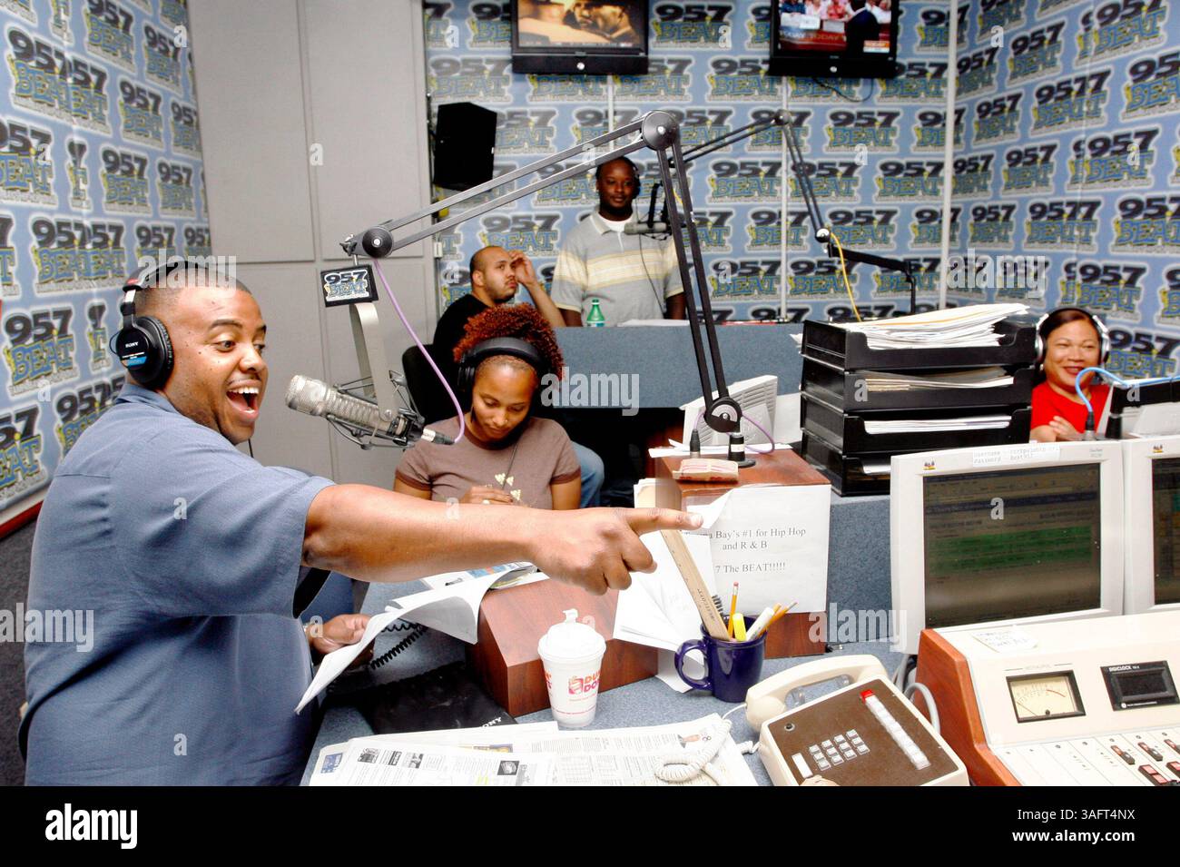 1 of 2.CAPTION : (TAMPA - 27/06/06) : (1) DJ invité Ernest Hooper (cq Times files / left) signale le producteur de spectacles ''Big Mike'' (hors caméra) sur 95,7 FM - l'émission de radio Beat Morning pour aller à une publicité. Le DJ animateur du spectacle, Olivia Fox (cq / Far right) s'amuse à Hoopers Antics. ''Suge Avery (cq / assis au centre en tan) se prépare à donner les nouvelles et les rapports de trafic tandis que les producteurs adjoints ''Tee'' (cq / arrière gauche assis) et DJ Chase ''Dudu'' (crédit image : St Petersburg Times/ZUMAPRESS.com) Banque D'Images