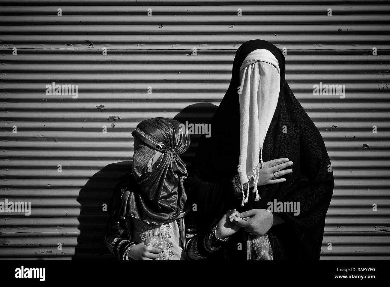 Dec. 5, 2011 - Khorramabad, Iran - chaque année pour marquer la mort de l'Imam Hussein, les musulmans chiites pleurent pendant deux jours. À Khorramabad et Lorestan, dans l’ouest de l’Iran, lors du premier jour de deuil, appelé Tasooa, les femmes font vœu de silence et traversent les rues avec les enfants allumant des bougies. À 4 heures du matin sur Ashura, le deuxième jour, les hommes se couvrent de boue et se tiennent devant un feu jusqu'à ce que la boue ait séché pour devenir argile. Après cela, ils vont à la mosquée et prient (crédit image : © Farhad Babaei/ZUMAPRESS.com) Banque D'Images