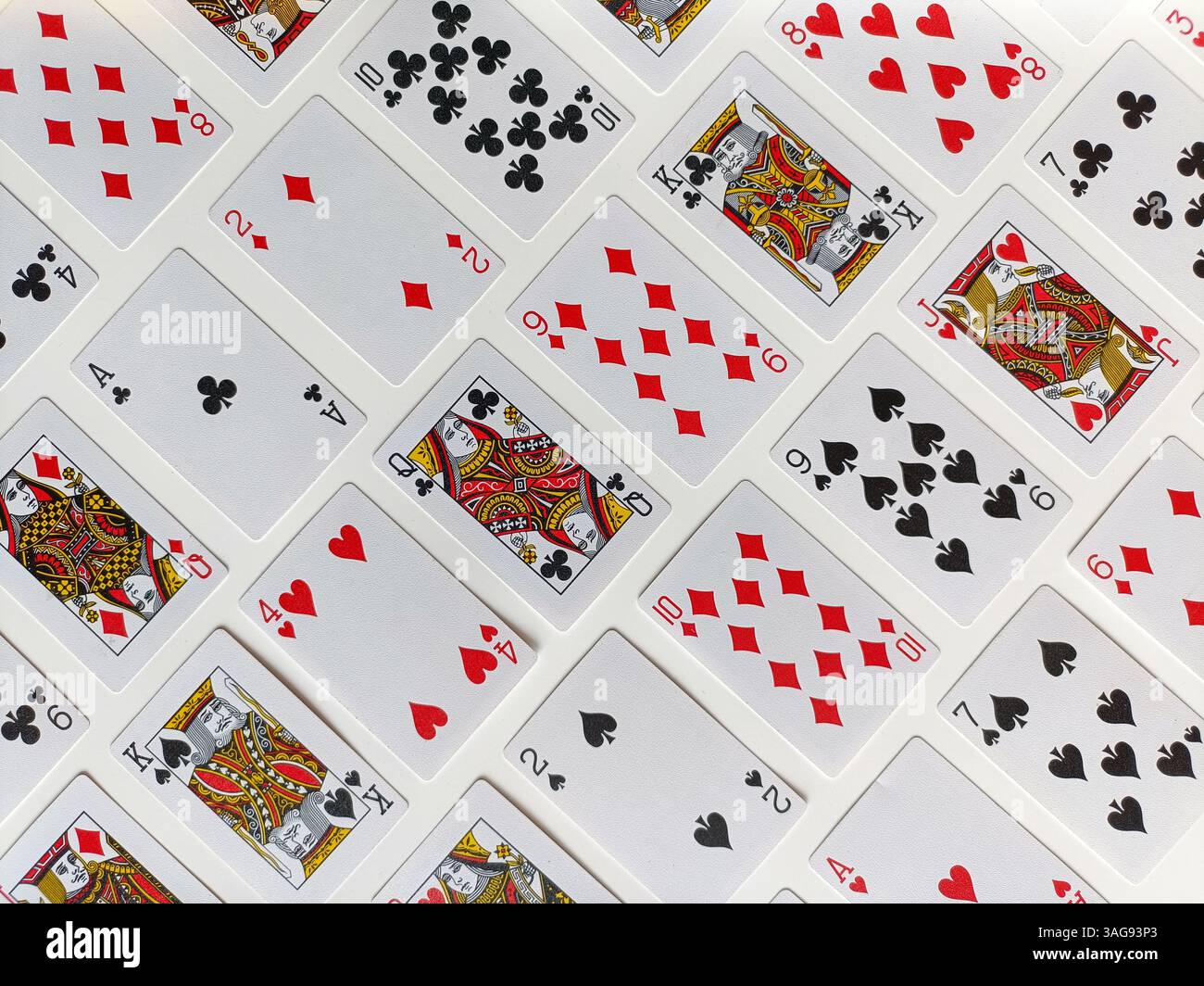 Une belle pose à plat de cartes à jouer classiques, parfaitement disposées dans un motif diagonal qui met en évidence à la fois la couleur et la symétrie. - Image de stock capturée avec un smartphone