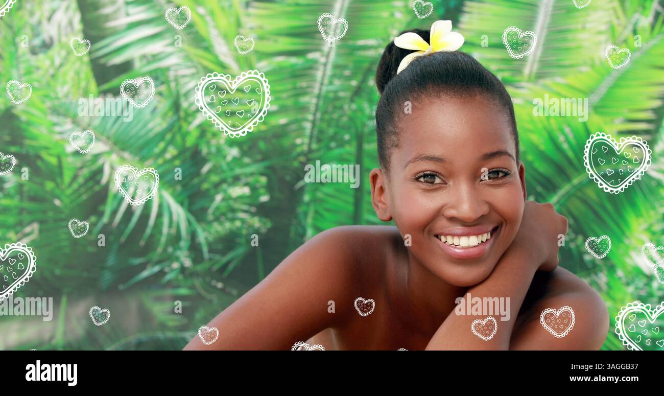 Portrait de belles femmes noires détendues souriant au spa avec une fleur d'orchidée dans les cheveux pour St va Banque D'Images