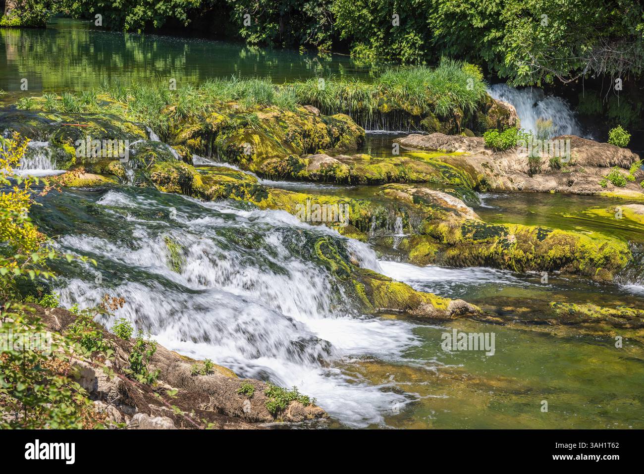 Cascade de Kocusa dans le village Veljaci, Bosnie-Herzégovine, Europe. Cascade pittoresque en cascade sur des rochers moussseux, entouré d'une végétation luxuriante sur un soleil Banque D'Images