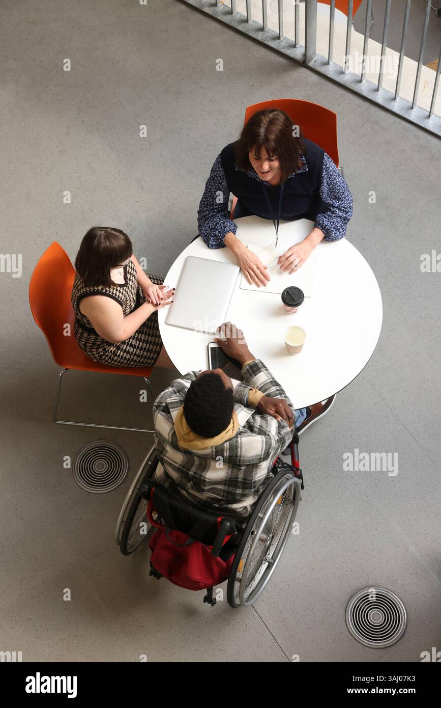 Personnes handicapées parlant à table Banque D'Images