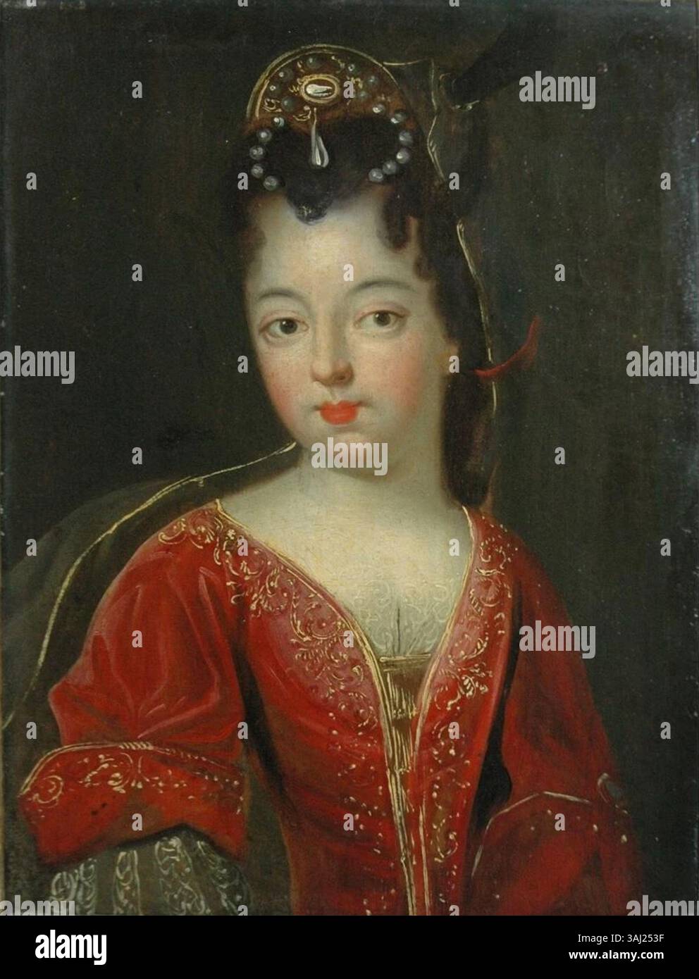 Ce portrait du XVIIe siècle de l'École française montre une dame vêtue de rouge, probablement de statut noble ou aristocratique. L'utilisation élégante de la couleur et de la composition met en valeur la tenue à la mode et l'équilibre du sujet. Banque D'Images
