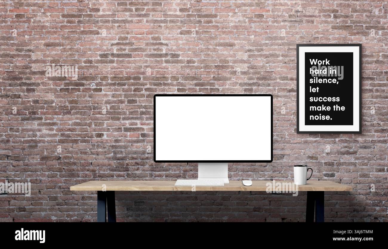Maquette de bureau avec moniteur sur le bureau de travail, mur de briques et cadre de motivation en arrière-plan, espace propre sur la gauche pour copie ou message de marque Banque D'Images