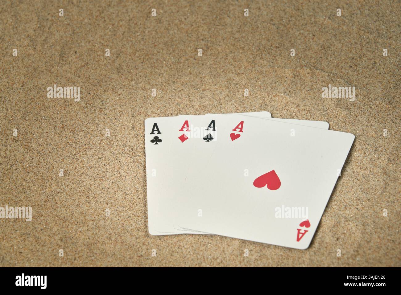Quatre as de la plate-forme de poker sur le sable de plage et parfait pour les arrière-plans avec de l'espace pour les textes Banque D'Images