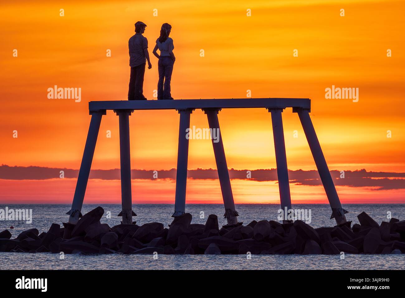 Vue au lever du soleil de la sculpture ''couple'' de Sean Henry à Newbiggin-by-the-Sea dans le Northumberland, au nord-est de l'Angleterre Banque D'Images