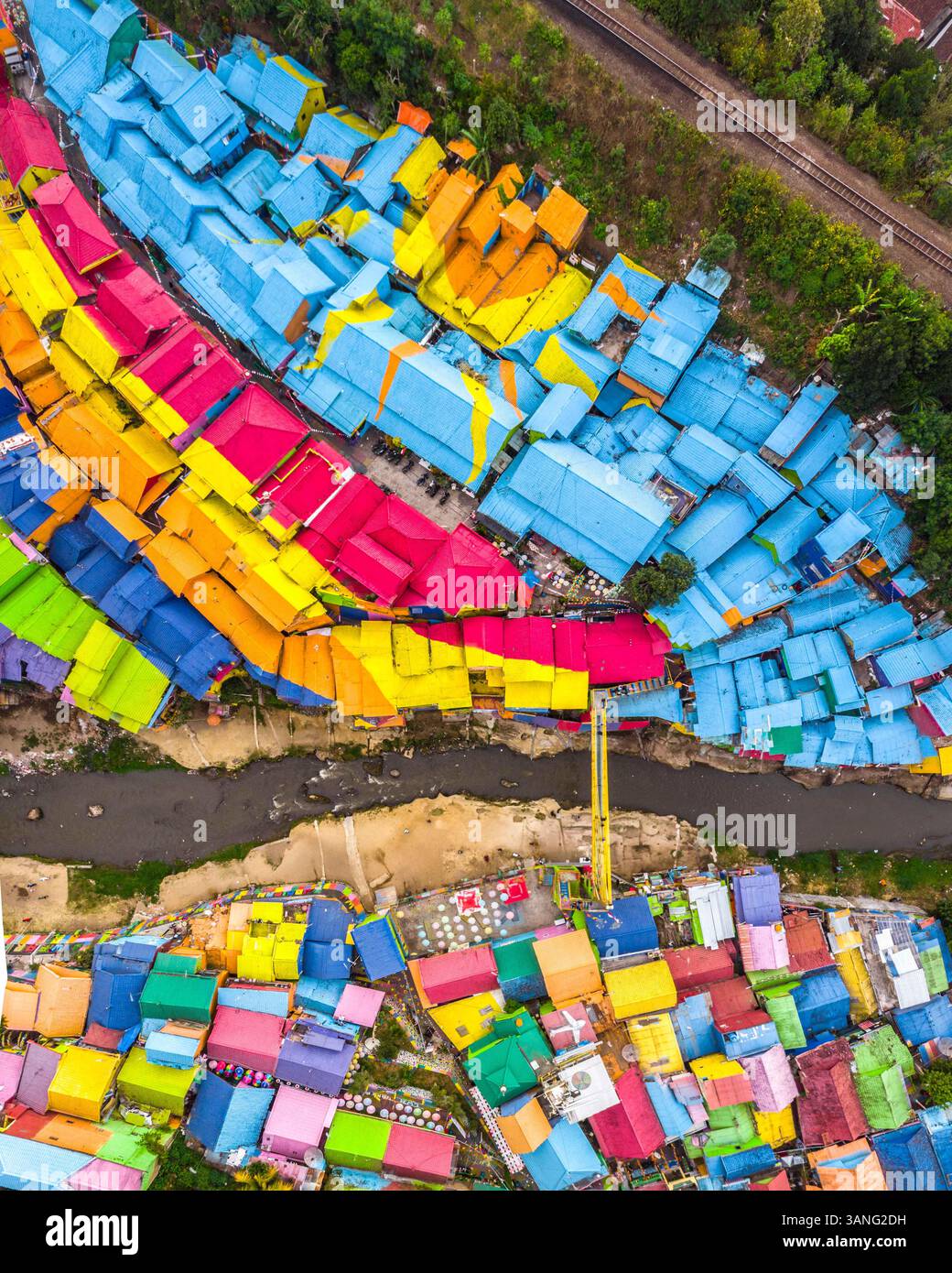 Vue aérienne des maisons colorées dans le village arc-en-ciel avec une rivière et le trafic, Malang City, Indonésie. Banque D'Images