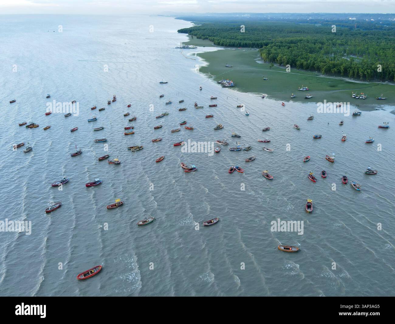 Vue aérienne de bateaux de pêche dynamiques dans la baie sereine du Bengale entourée de mangroves, Chittagong, Bangladesh. Banque D'Images
